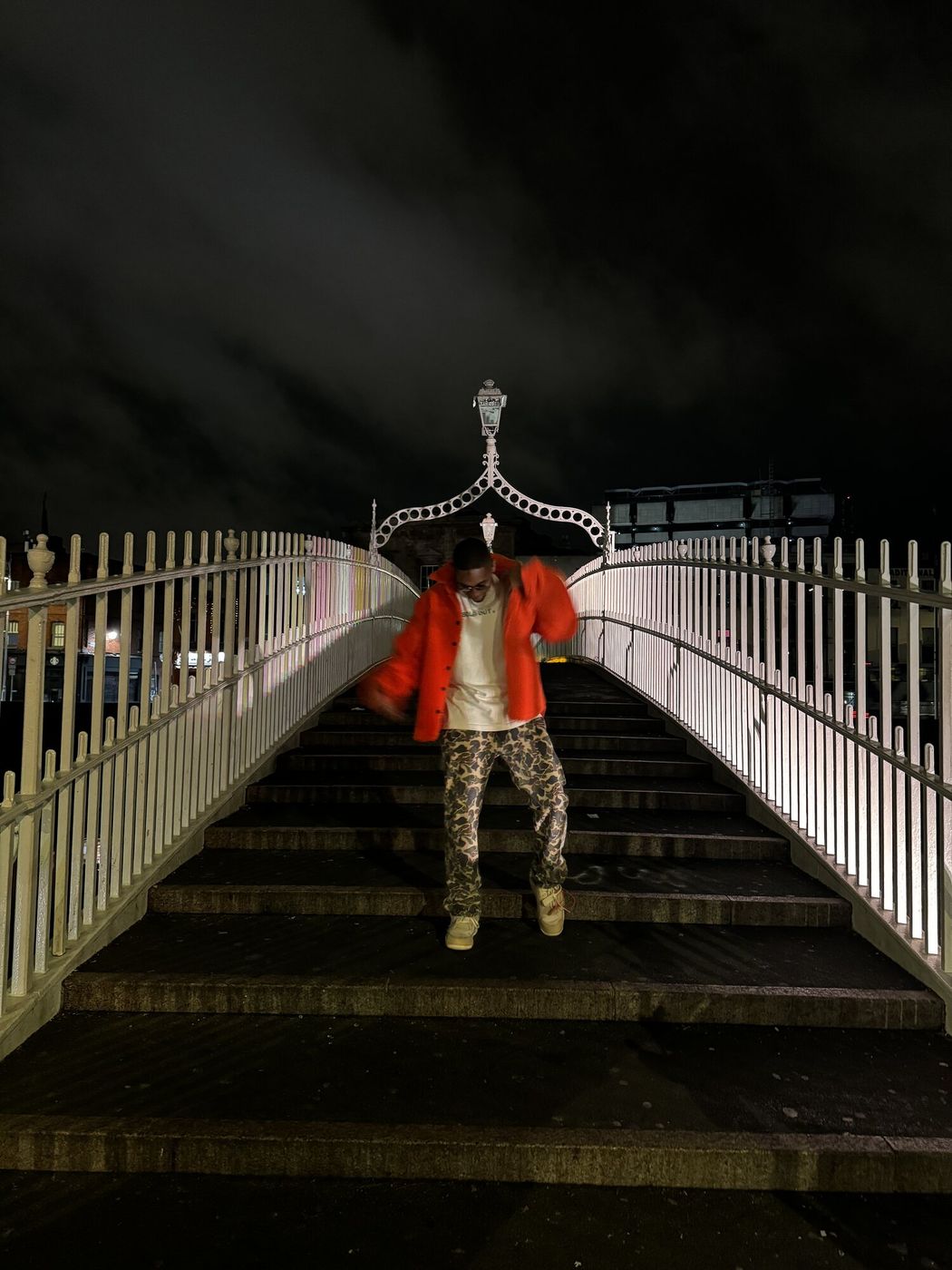 Night portrait on a lit bridge